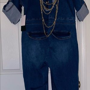 Jean romper cuffed legs . Cut out back with gold chains